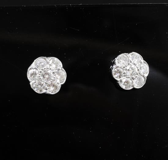 A pair of platinum and diamond seven-stone cluster ear studs, 12mm.